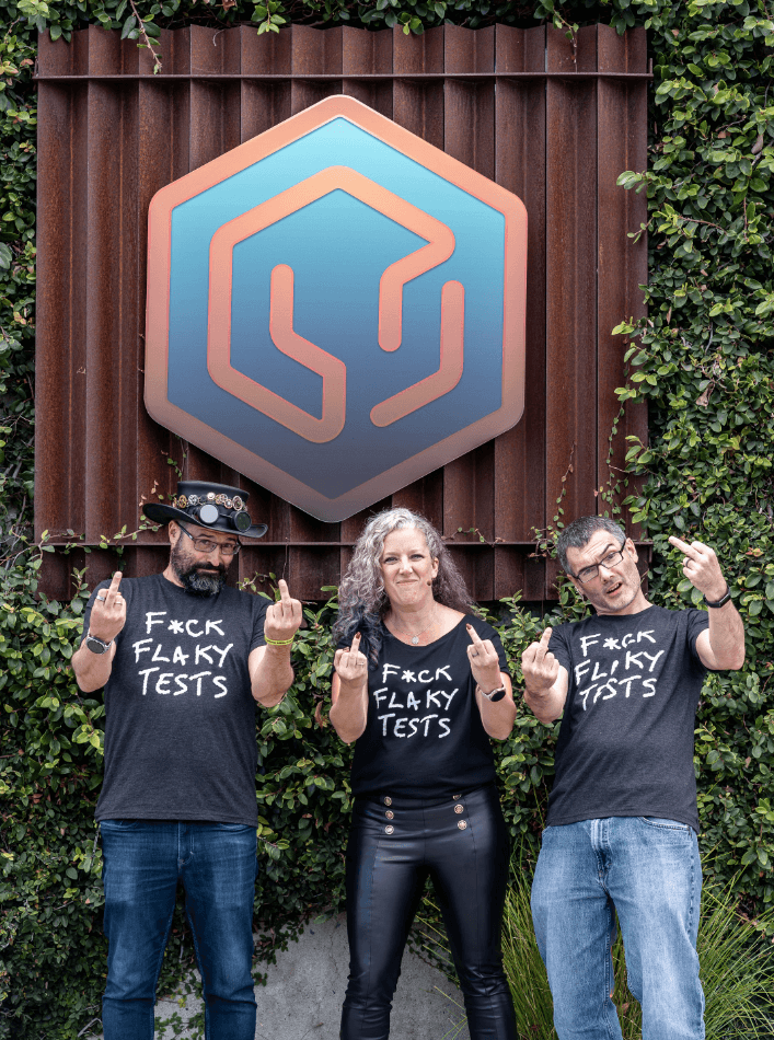 From left to right: Baruch, Trisha and Brian, wearing "F*ck Flaky Tests" t-shirts.